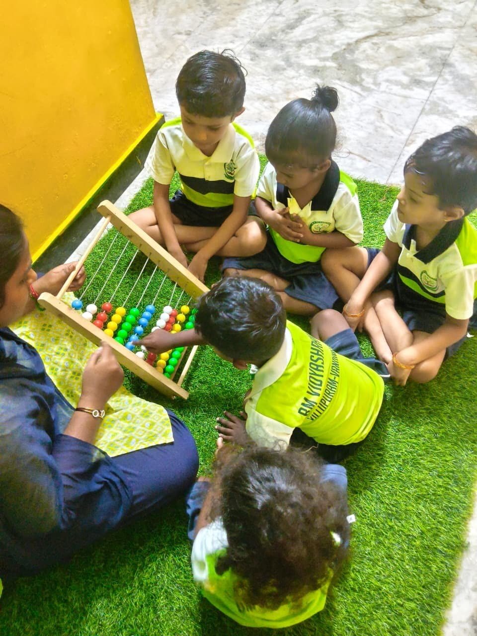 Children enjoying an abacus counting game