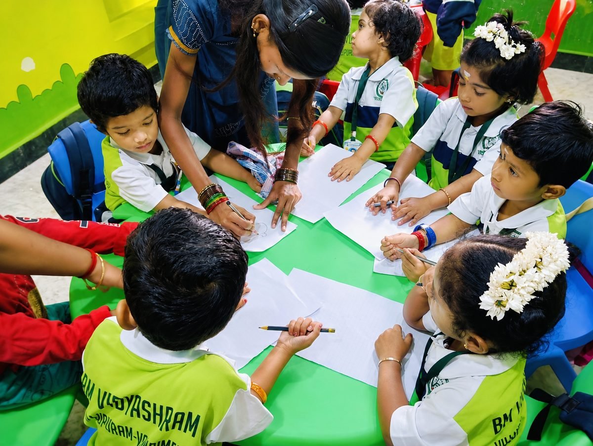 Teacher warmly guiding children through a drawing activity