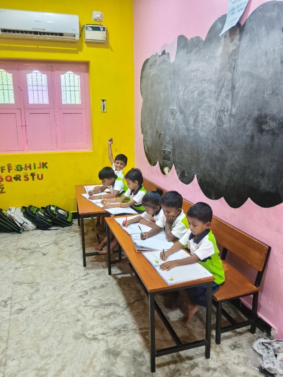 Child practising handwriting at BM Vidyashram