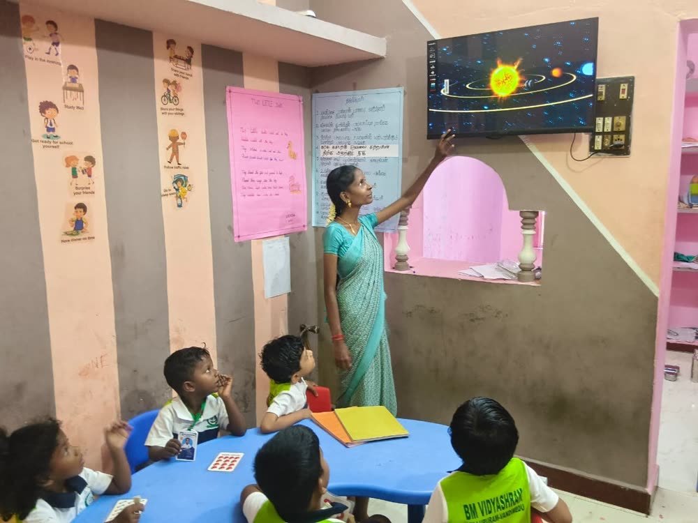 Teacher using a smart TV for a solar system lesson
