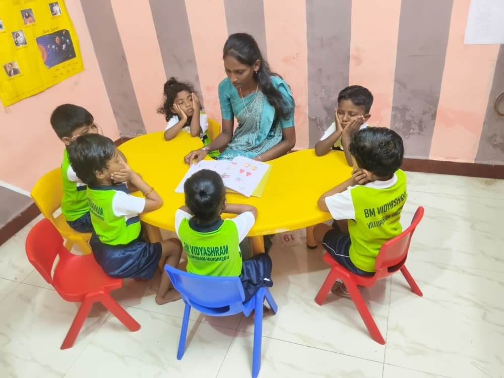 Teacher reading a story to children at BM Vidyashram